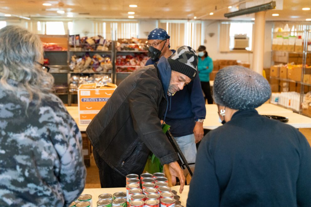 a man gets food at a pantry