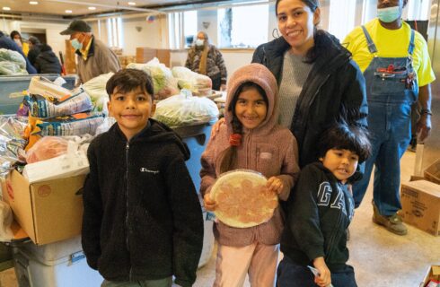 a mother and her three children at a food pantry