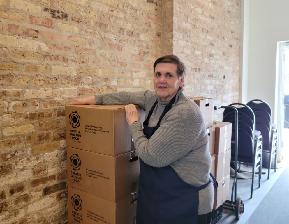 a woman leans on a stack of boxes