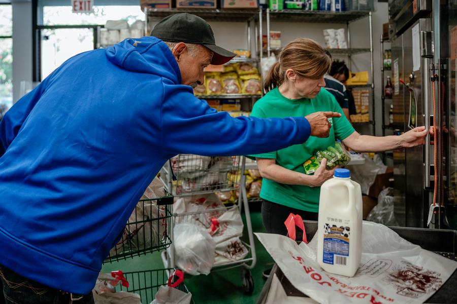 Un voluntario de la comunidad ayudando a distribuir alimentos en una despensa local.