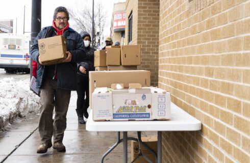 Man carrying box of fresh food.