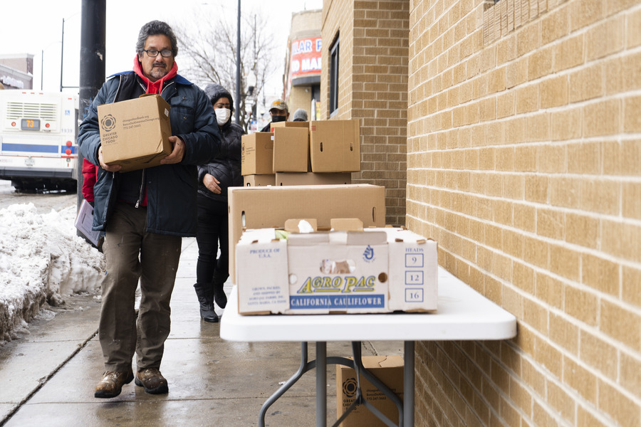 Man carrying box of fresh food.