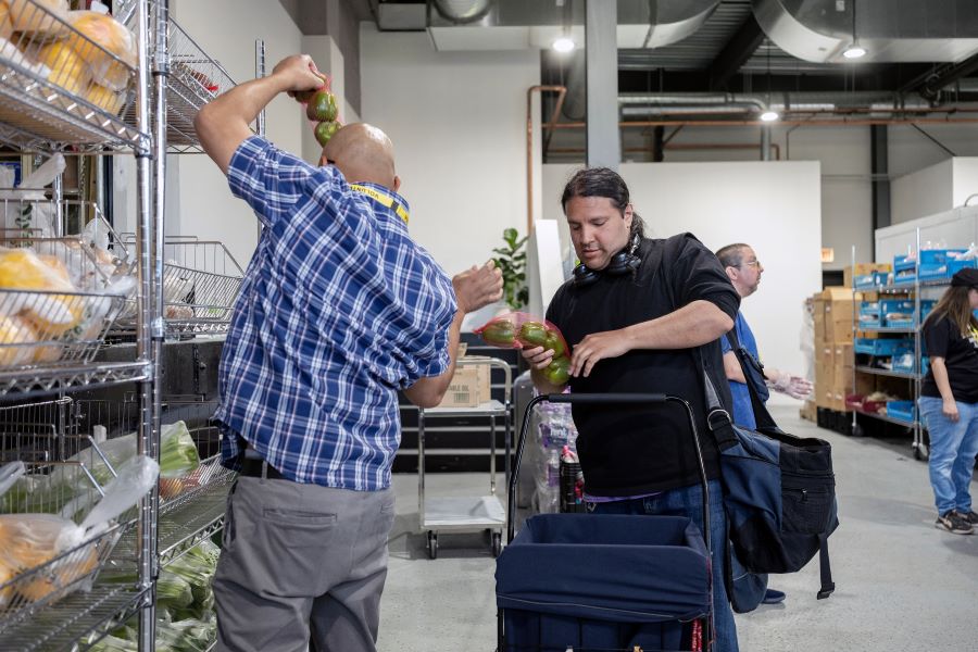 A man puts food into a cart